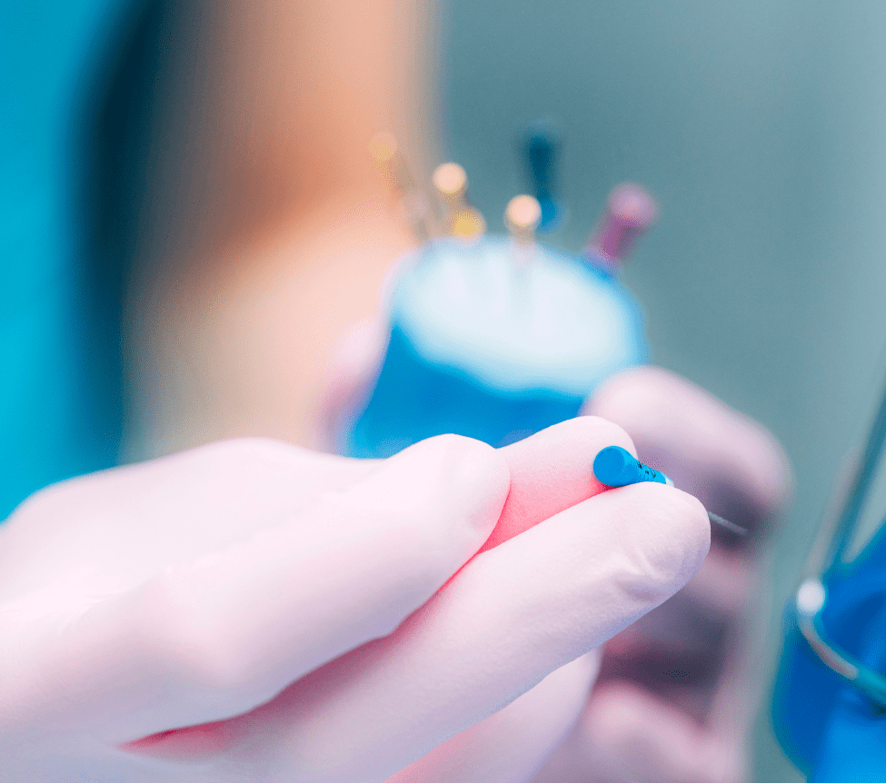 Dental tools and instruments held by a gloved hand, emphasizing precision in restorative dentistry procedures at Harborside Dental.